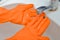 A woman washes her hands in master rubber gloves in a sink underwater