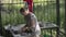 Woman washes with a soapy sponge a glass jar in the summer kitchen in country