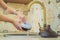 Woman washing aroma diffuser in faucet. Aromatherapy Concept. Wooden Electric Ultrasonic Essential Oil Aroma Diffuser