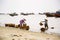 Woman washing baskets for anchovies used for fish sauce on February 7, 2012 in Mui Ne, Vietnam.