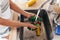 Woman washing cucumbers in kitchen sink close up.