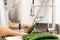 Woman washing cucumbers in running water in kitchen sink.