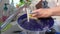 Woman washing dirty dishes in kitchen sink