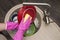 Woman washing dishes in the kitchen. Close up of woman hand. Housewife clean dishes. Housework in the kitchen