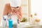 Woman washing face above bathroom sink