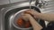 Woman washing freshly picked organic tomatoes in colander