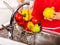 Woman washing fruit at kitchen.