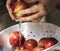 Woman washing fruits under running tap