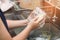 A woman washing glass by dish soap