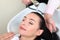 Woman washing hair in salon pool