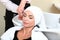 Woman washing hair in salon pool