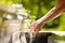 Woman washing hands in a city fountain