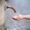 Woman washing hands in a city fountain in Rome, Italy