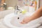 Woman washing hands with soap in bathroom. People and healthcare concept