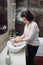 woman washing hands with soap and sanitiser in bathroom, details of hygiene, disinfecting hands