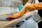 Woman washing modern  cooktop cooking panel in kitchen