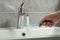 Woman washing plastic toothbrush under flowing water from faucet in bathroom, closeup