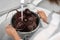 Woman washing ripe beets in kitchen sink