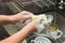 A woman washing stainless spoon by dish soap