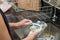 A woman washing stainless spoon by dish soap make many bubble