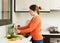 Woman washing vegetables in kitchen