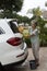 Woman washing the windscreen of a white saloon car