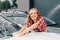 Woman washing windshield of car with sponge and foam