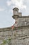 Woman and watch tower of ruined Pidhirtsi Castle in Ukraine.