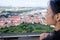 Woman watches cityscape of Prague