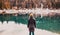 woman watchin amazing turquoise water of Caumasee in winter Switzerland slow travel