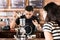 Woman watching barista preparing drip coffee in cafe