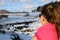 Woman watching beautiful frozen rapids