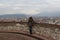 Woman is watching Brescia cityscape from the Castle`s tower. Lombardy, Italy