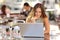 Woman watching media in a laptop in a coffee shop