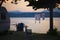 Woman watching pink sunset while sitting at campground in Manerba del Garda, Italy