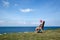 Woman watching view at coastline from a chair