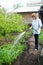 Woman watering garden beds
