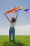A woman waves a rainbow LGBT flag standing with back