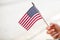 Woman Waving Small American Flag During Parade