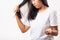 Woman weak hair problem her use comb hairbrush brush her hair and showing damaged long loss hair from the brush on hand