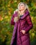 Woman wear extra volume jacket. Girl fashionable blonde walk autumn park. Jackets everyone should have. Best puffer coat