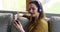 Woman wear headphones using smartphone take part in videocall