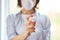 Woman wear hygienic mask and press alcohol spray to protect, sanitizing.