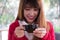 Woman wear red sweater at restaurant. girl hold latte coffee cup