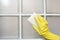 Woman wear rubber gloves cleaning tile wall