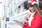 Woman wear santa hat holding tablet at her shop. asian female we