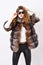 Woman wear sunglasses and hairstyle posing mink or sable fur coat. Fur fashion concept. Winter elite luxury clothes