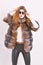 Woman wear sunglasses and hairstyle posing mink or sable fur coat. Fur fashion concept. Winter elite luxury clothes