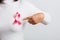 Woman wear white shirt pointing finger to pink breast cancer awareness ribbon