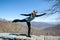 Woman wearing athleisue gear does a yoga pose overlooking the Blue Ridge Mountains in Shenandoah National Park in Virginia